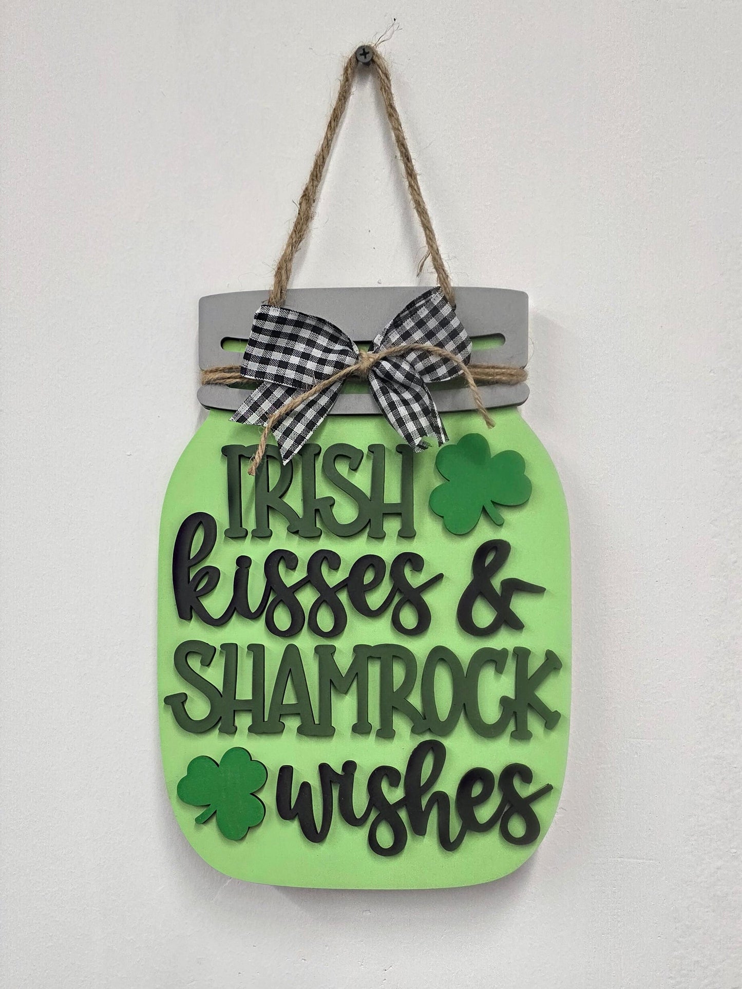 Decorative tag with shamrock design and text on a light gray background