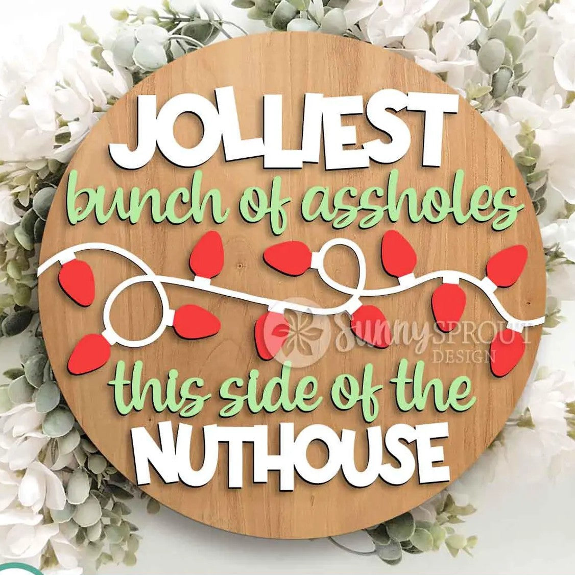 Wooden round sign with humorous text and red lights on a floral background