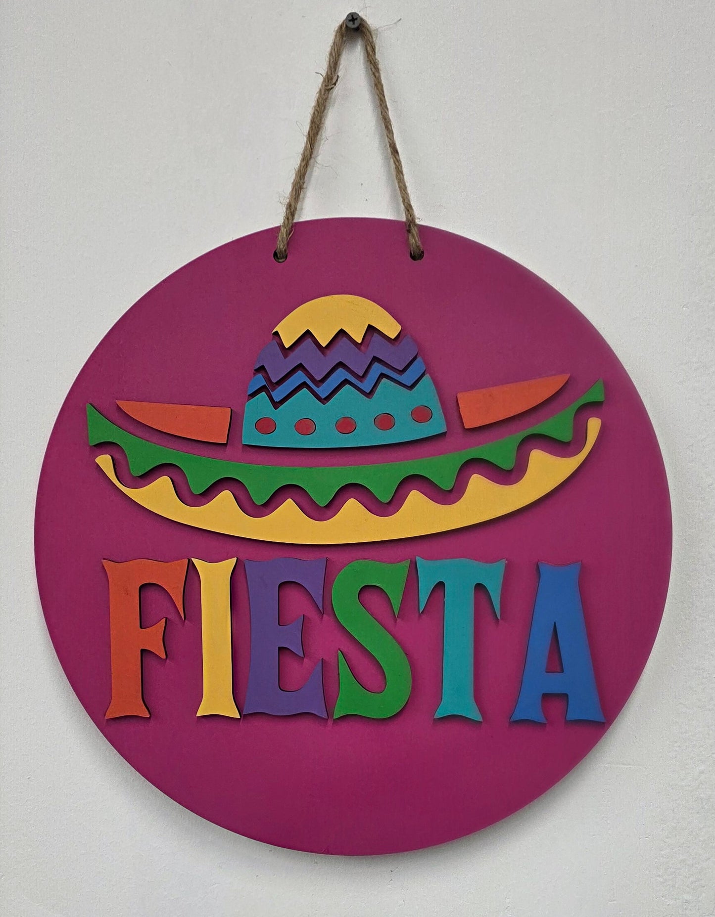 Decorative sign with colorful design and 'Fiesta' text on a purple background