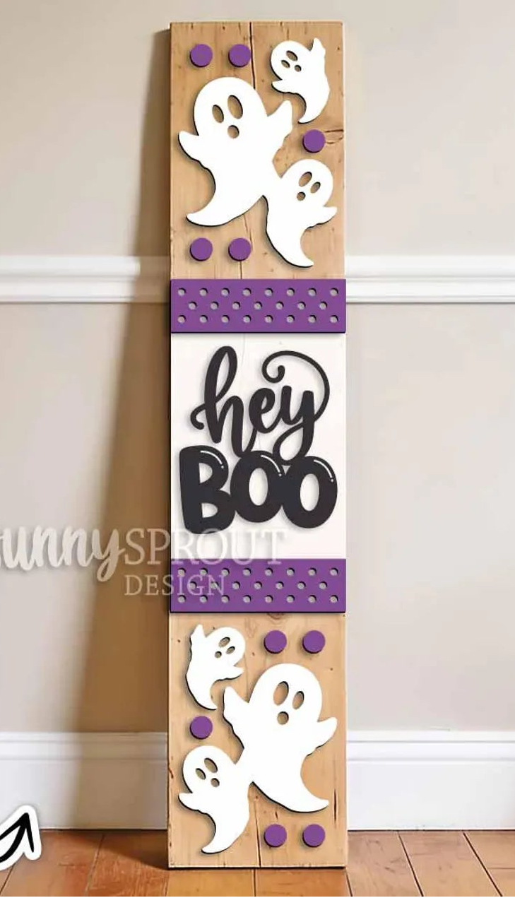 Wood Porch Leaner with ghosts and the words hey boo on it painted purple and white with a stained background.