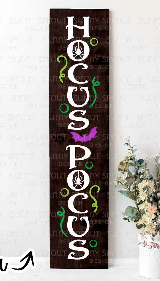 Decorative sign with 'HOCUS POCUS' text on a white background