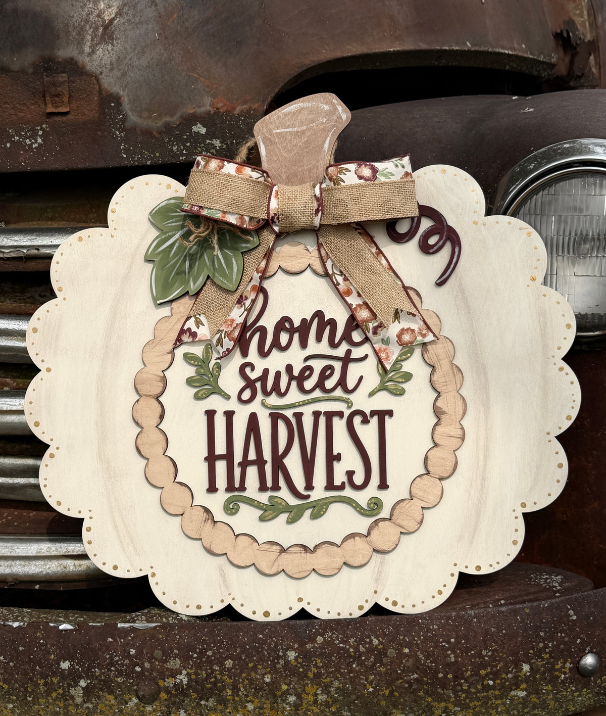 Wood pumpkin with words that say home sweet harvest. 