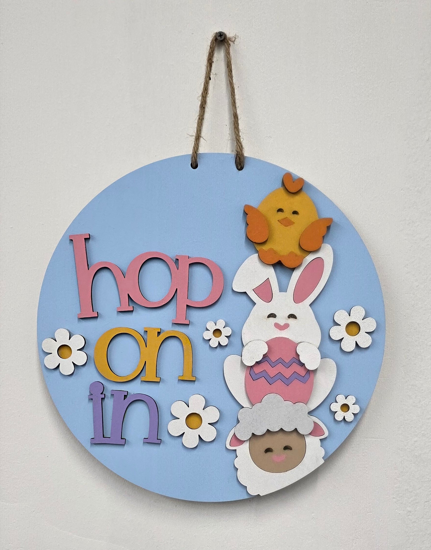 Decorative round sign with cartoon characters and text on a light gray background
