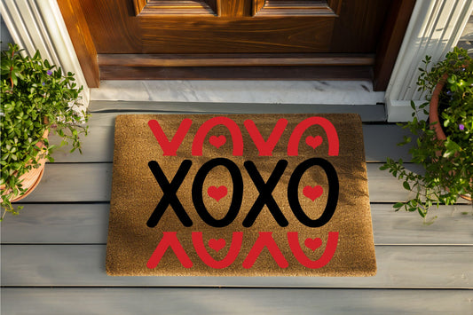 Doormat with 'Viva XOXO' text on a wooden porch